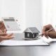 2 personnes dont on voit que les mains discutes d'immobilier